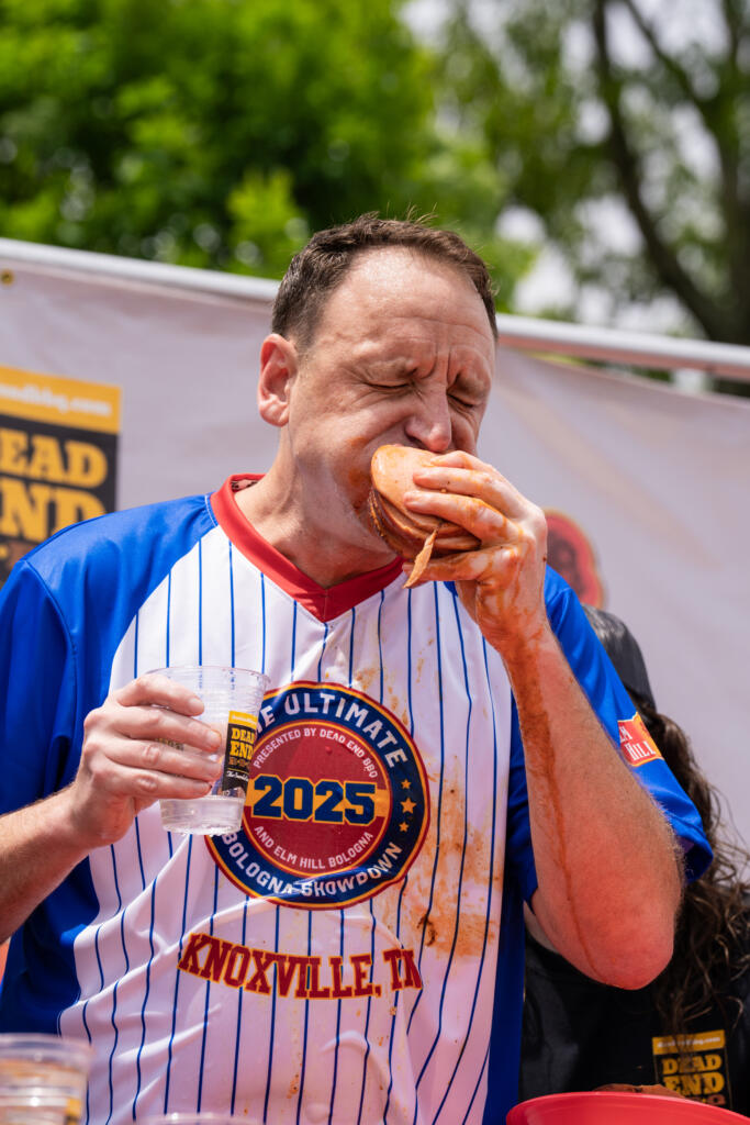 joey chestnut in action during the ultimate bologna showdown, an annual bbq eating competition in knoxville, tn put on by dead end bbq, a local restaurant 
