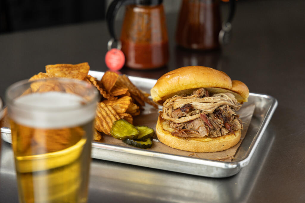 pulled pork sandwich and hand-cut sweet potato waffle fries combo with a beer from dead end bbq in knoxville